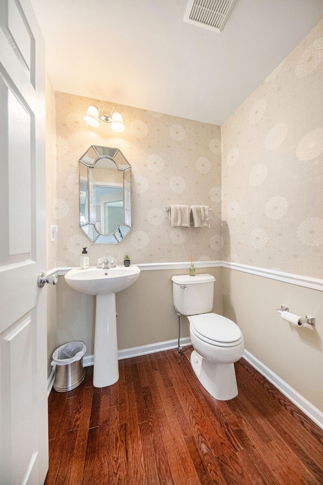 440 Shiloh Dr, Chelsea, MI 48118 - half bathroom featuring wood finished floors and wallpapered walls