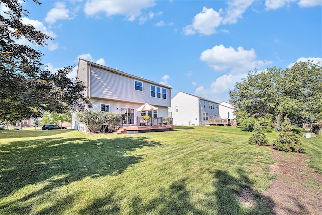 440 Shiloh Dr, Chelsea, MI 48118 - rear view of house featuring a deck and a lawn
