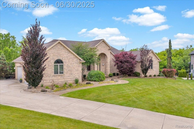 550 Kings Fairway Ct, Grand Blanc, MI 48439 - view of front of home with brick siding, concrete driveway, a front lawn, and a garage