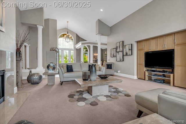 550 Kings Fairway Ct, Grand Blanc, MI 48439 - living room featuring decorative columns, light carpet, high vaulted ceiling, and a chandelier
