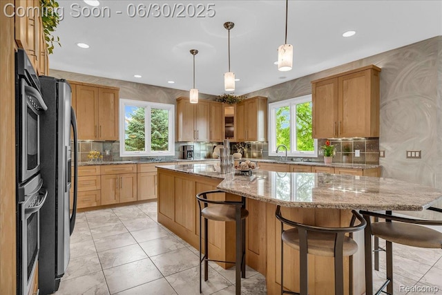 550 Kings Fairway Ct, Grand Blanc, MI 48439 - kitchen featuring decorative backsplash, healthy amount of natural light, a center island, light stone countertops, and recessed lighting