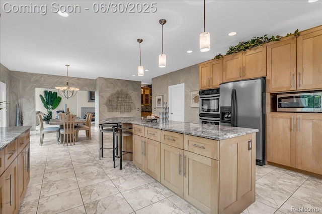 550 Kings Fairway Ct, Grand Blanc, MI 48439 - kitchen with appliances with stainless steel finishes, stone countertops, light brown cabinetry, light marble finish floors, and recessed lighting