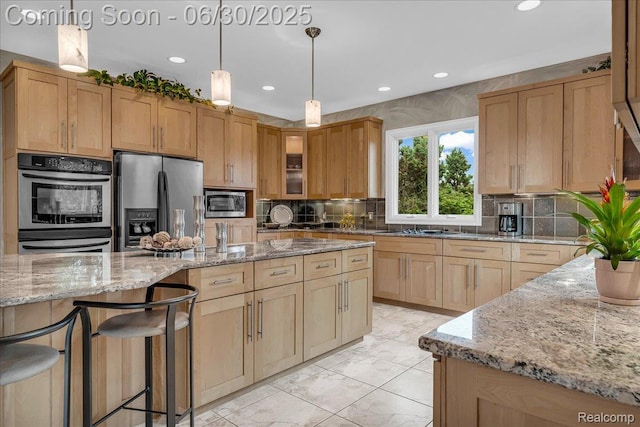 550 Kings Fairway Ct, Grand Blanc, MI 48439 - kitchen featuring appliances with stainless steel finishes, light stone countertops, tasteful backsplash, glass insert cabinets, and light brown cabinetry