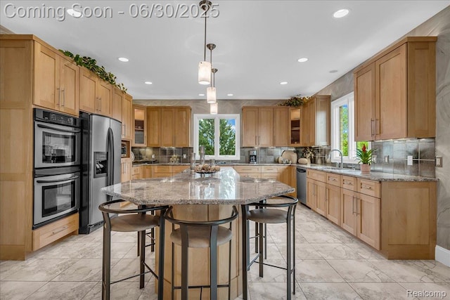 550 Kings Fairway Ct, Grand Blanc, MI 48439 - kitchen featuring appliances with stainless steel finishes, a breakfast bar area, light stone countertops, a kitchen island, and recessed lighting