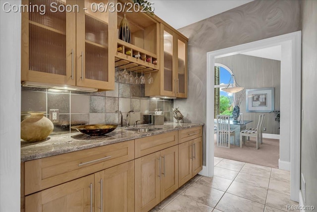 550 Kings Fairway Ct, Grand Blanc, MI 48439 - kitchen with light stone countertops, decorative backsplash, glass insert cabinets, and light brown cabinets