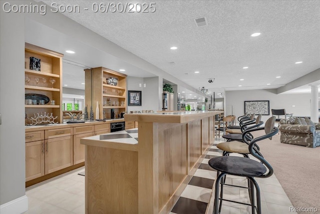 550 Kings Fairway Ct, Grand Blanc, MI 48439 - kitchen with open shelves, open floor plan, a textured ceiling, recessed lighting, and a breakfast bar area
