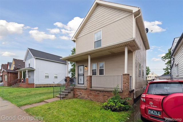 2450 Hewitt St, Hamtramck, MI 48212 - view of front of house with covered porch and a front yard