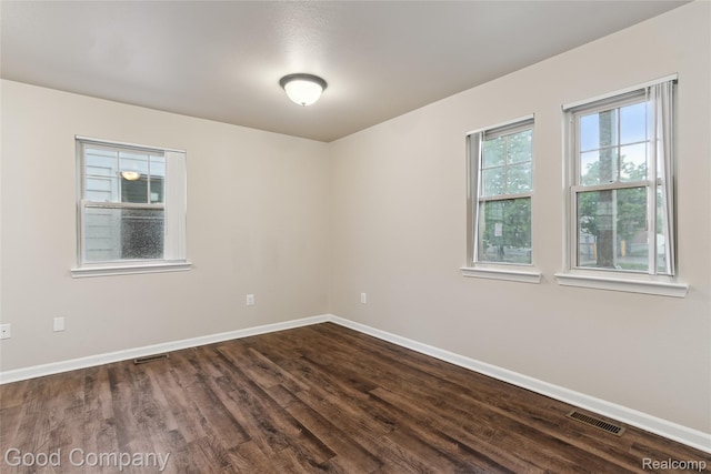 2450 Hewitt St, Hamtramck, MI 48212 - unfurnished room featuring baseboards and dark wood-type flooring