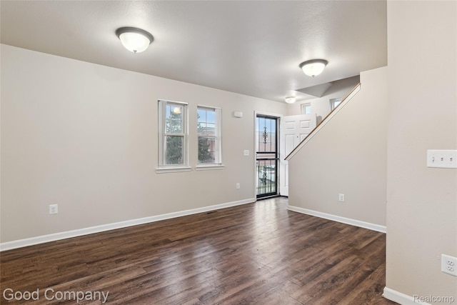2450 Hewitt St, Hamtramck, MI 48212 - empty room with dark wood-type flooring and stairway