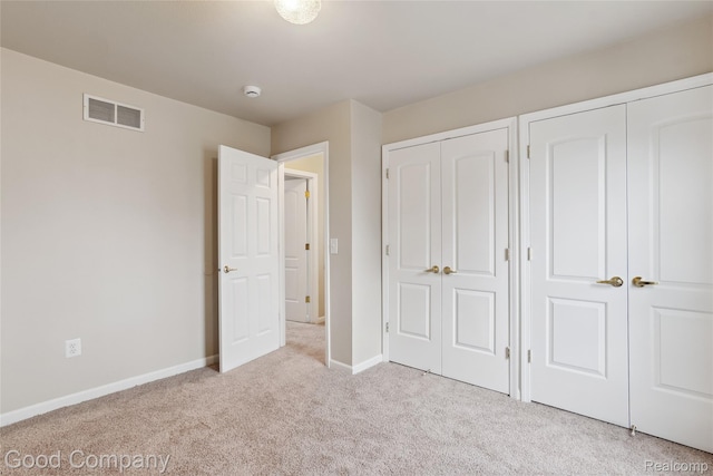 2450 Hewitt St, Hamtramck, MI 48212 - unfurnished bedroom featuring carpet and multiple closets