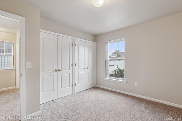 2450 Hewitt St, Hamtramck, MI 48212 - unfurnished bedroom with carpet and multiple closets