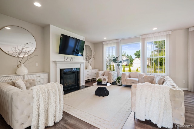 1957 Emerald Ln, Wixom, MI 48393 - living room featuring dark wood-style flooring, recessed lighting, a fireplace, and healthy amount of natural light