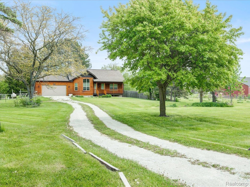 4300 Carrigan Rd, Fort Gratiot, MI 48059 - log cabin with a garage and driveway