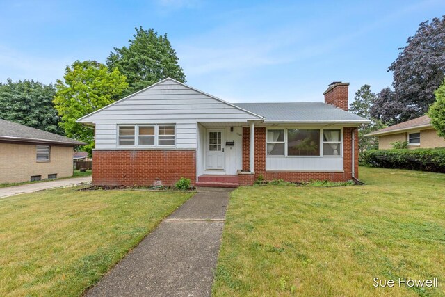 1547 Edith Ave NE, Grand Rapids, MI 49505 - bungalow-style house with brick siding, a front lawn, and a chimney
