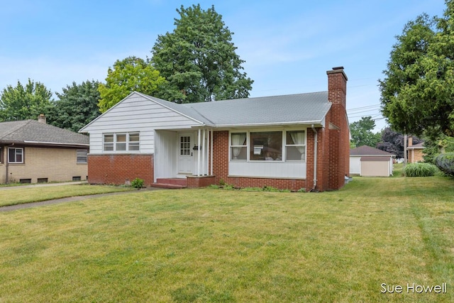 1547 Edith Ave NE, Grand Rapids, MI 49505 - view of front of house with brick siding, a chimney, and a front lawn