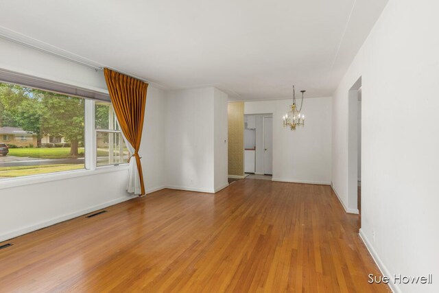 1547 Edith Ave NE, Grand Rapids, MI 49505 - unfurnished room with a chandelier and light wood-style floors