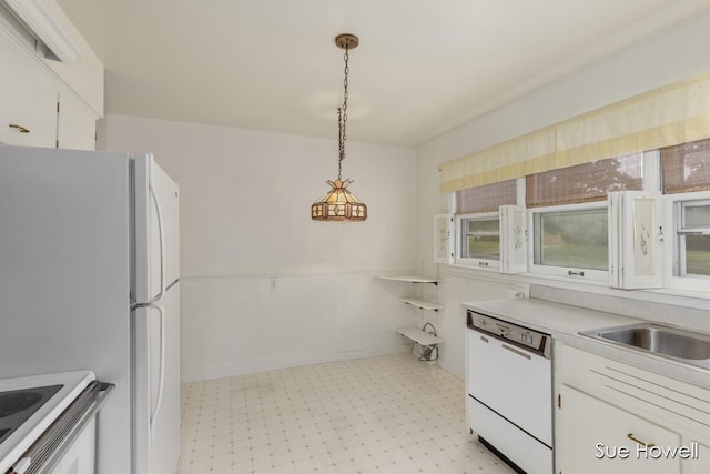 1547 Edith Ave NE, Grand Rapids, MI 49505 - kitchen featuring white appliances, light floors, light countertops, white cabinets, and decorative light fixtures