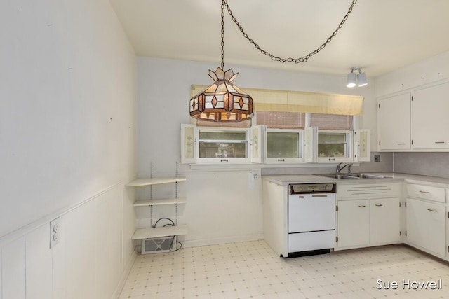1547 Edith Ave NE, Grand Rapids, MI 49505 - kitchen with dishwasher, white cabinetry, light countertops, light floors, and decorative light fixtures