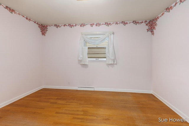1547 Edith Ave NE, Grand Rapids, MI 49505 - unfurnished room with light wood-style floors and a baseboard heating unit
