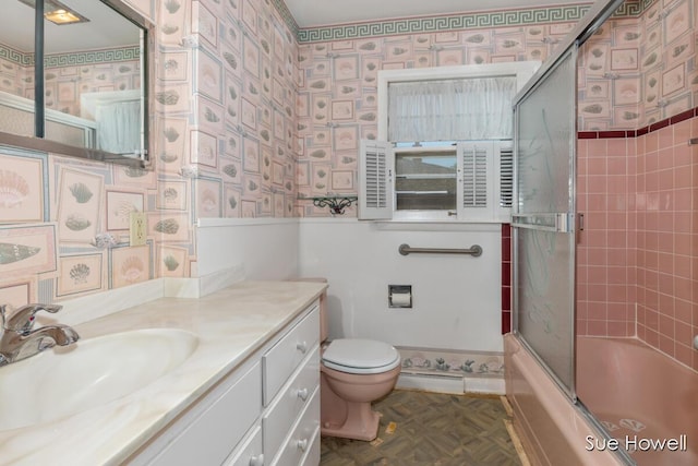 1547 Edith Ave NE, Grand Rapids, MI 49505 - bathroom with wallpapered walls, vanity, bath / shower combo with glass door, and a wainscoted wall