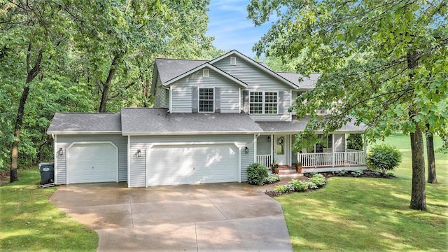 8601 Hathaway Rd, Kalamazoo, MI 49009 - traditional-style house with covered porch, driveway, a front lawn, a garage, and a shingled roof