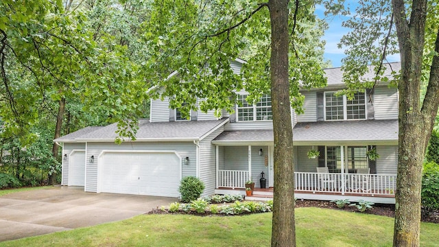 8601 Hathaway Rd, Kalamazoo, MI 49009 - traditional-style home featuring covered porch, concrete driveway, a front yard, and roof with shingles