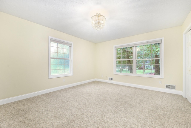 8601 Hathaway Rd, Kalamazoo, MI 49009 - spare room featuring a chandelier and carpet