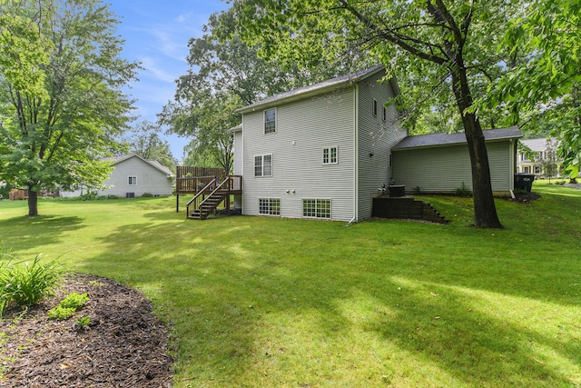 8601 Hathaway Rd, Kalamazoo, MI 49009 - rear view of house featuring stairs, a lawn, and a wooden deck