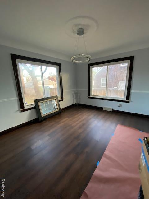14402 Southfield Rd, Detroit, MI 48223 - empty room featuring healthy amount of natural light and dark wood finished floors