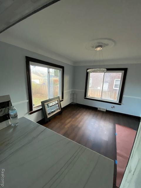 14402 Southfield Rd, Detroit, MI 48223 - unfurnished bedroom with multiple windows, dark wood-type flooring, and radiator heating unit