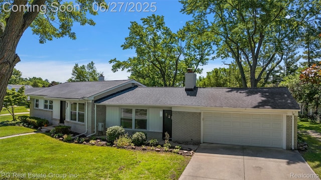 4550 Justine St, Shelby Twp, MI 48317 - view of front facade with brick siding, an attached garage, concrete driveway, a front lawn, and a chimney