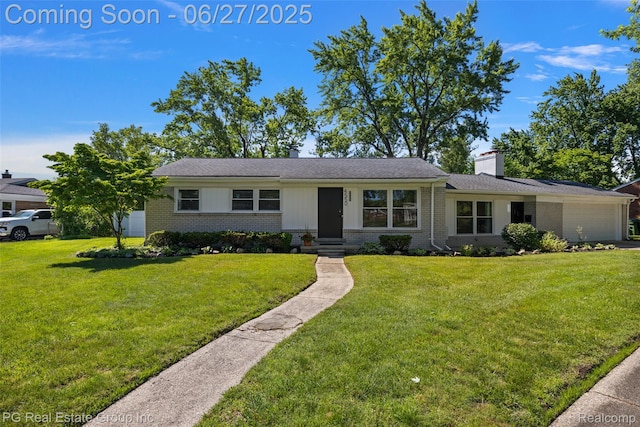 4550 Justine St, Shelby Twp, MI 48317 - view of front facade featuring brick siding, a garage, a front lawn, and a chimney