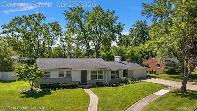 4550 Justine St, Shelby Twp, MI 48317 - view of front of property with brick siding, an attached garage, driveway, a chimney, and a shingled roof