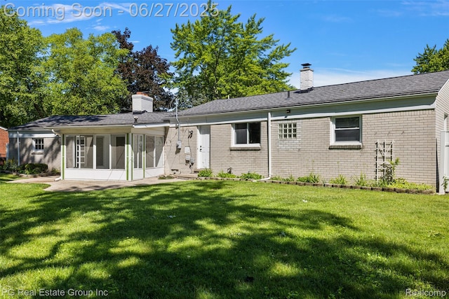 4550 Justine St, Shelby Twp, MI 48317 - rear view of property featuring a chimney, a lawn, and brick siding