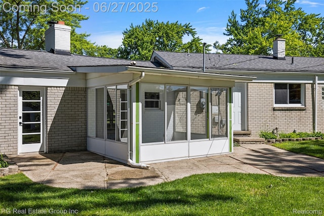 4550 Justine St, Shelby Twp, MI 48317 - back of house featuring a sunroom, a chimney, and brick siding