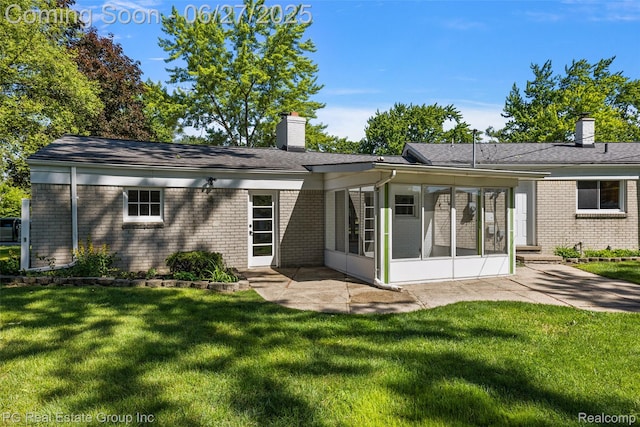 4550 Justine St, Shelby Twp, MI 48317 - back of property featuring a chimney, a sunroom, brick siding, and a yard