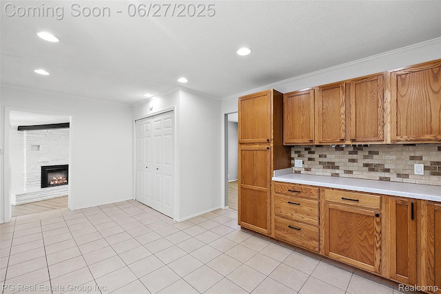 4550 Justine St, Shelby Twp, MI 48317 - kitchen featuring crown molding, brown cabinetry, light countertops, decorative backsplash, and recessed lighting