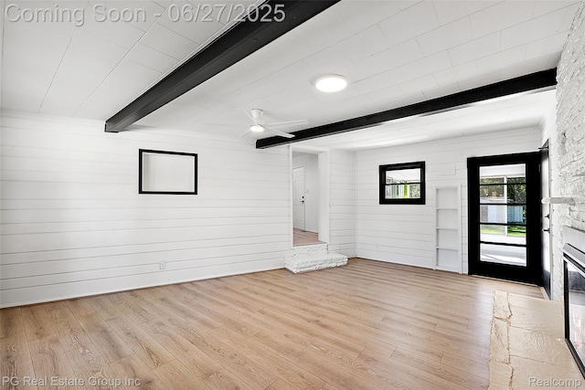 4550 Justine St, Shelby Twp, MI 48317 - foyer with beam ceiling, a fireplace, wood finished floors, a ceiling fan, and wood walls