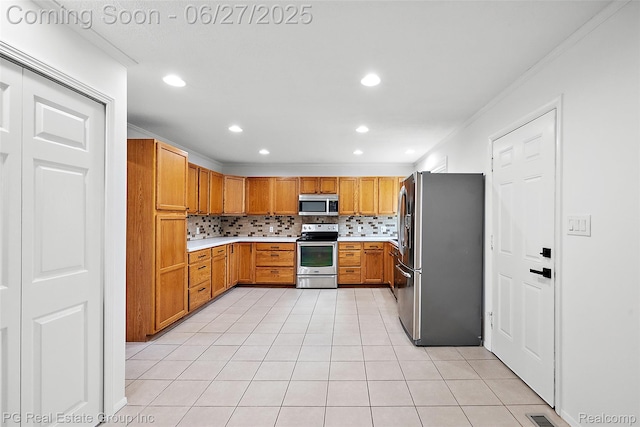 4550 Justine St, Shelby Twp, MI 48317 - kitchen with stainless steel appliances, crown molding, backsplash, light countertops, and light tile patterned floors