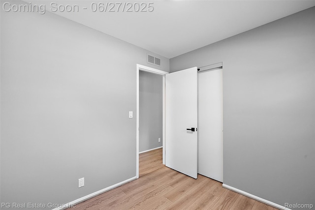 4550 Justine St, Shelby Twp, MI 48317 - unfurnished bedroom featuring wood finished floors and a closet