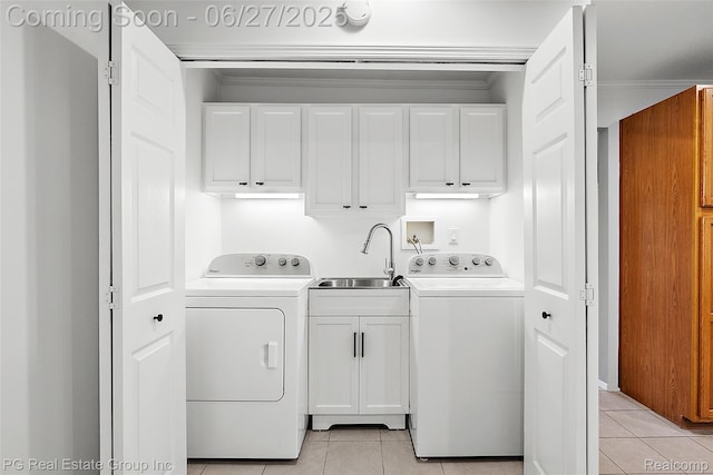 4550 Justine St, Shelby Twp, MI 48317 - washroom featuring cabinet space, light tile patterned floors, washing machine and clothes dryer, and ornamental molding