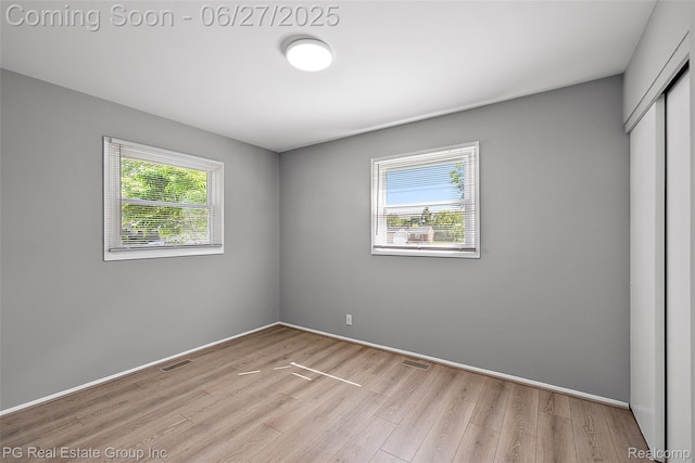4550 Justine St, Shelby Twp, MI 48317 - unfurnished bedroom featuring light wood finished floors and a closet