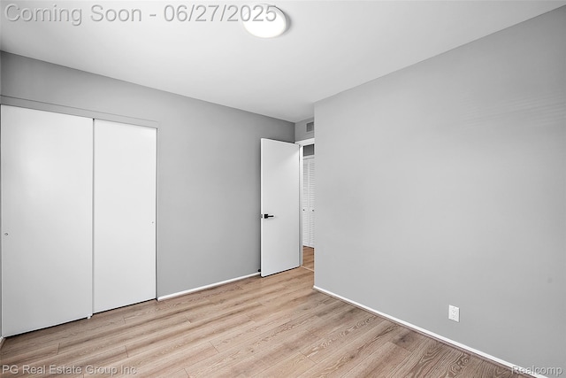 4550 Justine St, Shelby Twp, MI 48317 - unfurnished bedroom featuring wood finished floors and a closet