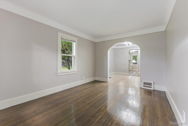 192 W Hopkins Ave, West Bloomfield, MI 48340 - empty room with plenty of natural light, arched walkways, and wood finished floors