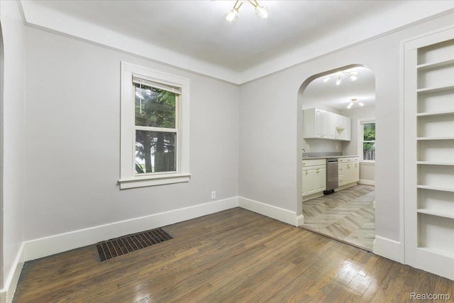 192 W Hopkins Ave, West Bloomfield, MI 48340 - unfurnished room with wood finished floors and arched walkways