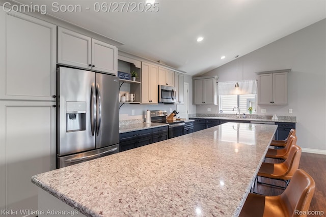 11785 Cardwell St, Dearborn Heights, MI 48150 - kitchen featuring stainless steel appliances, open shelves, a kitchen island, vaulted ceiling, and a kitchen breakfast bar