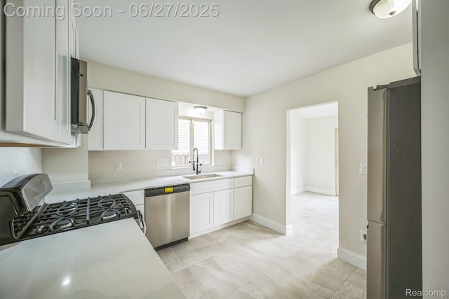 1730 E Woodruff Ave, Hazel Park, MI 48030 - kitchen with appliances with stainless steel finishes, light countertops, and white cabinetry