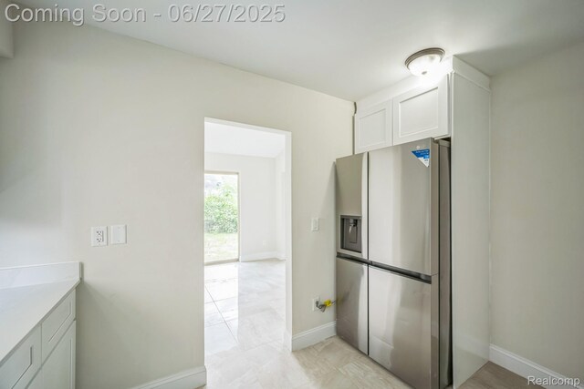 1730 E Woodruff Ave, Hazel Park, MI 48030 - kitchen featuring stainless steel fridge, white cabinets, and light countertops
