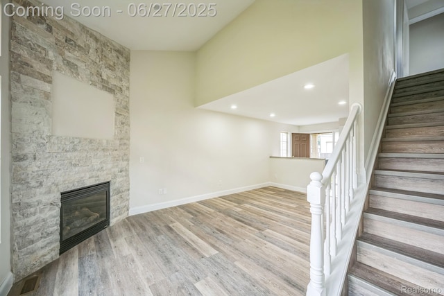 1730 E Woodruff Ave, Hazel Park, MI 48030 - unfurnished living room featuring a fireplace, stairway, wood finished floors, and recessed lighting