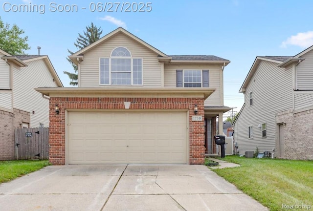 1730 E Woodruff Ave, Hazel Park, MI 48030 - traditional-style home featuring brick siding, an attached garage, and driveway